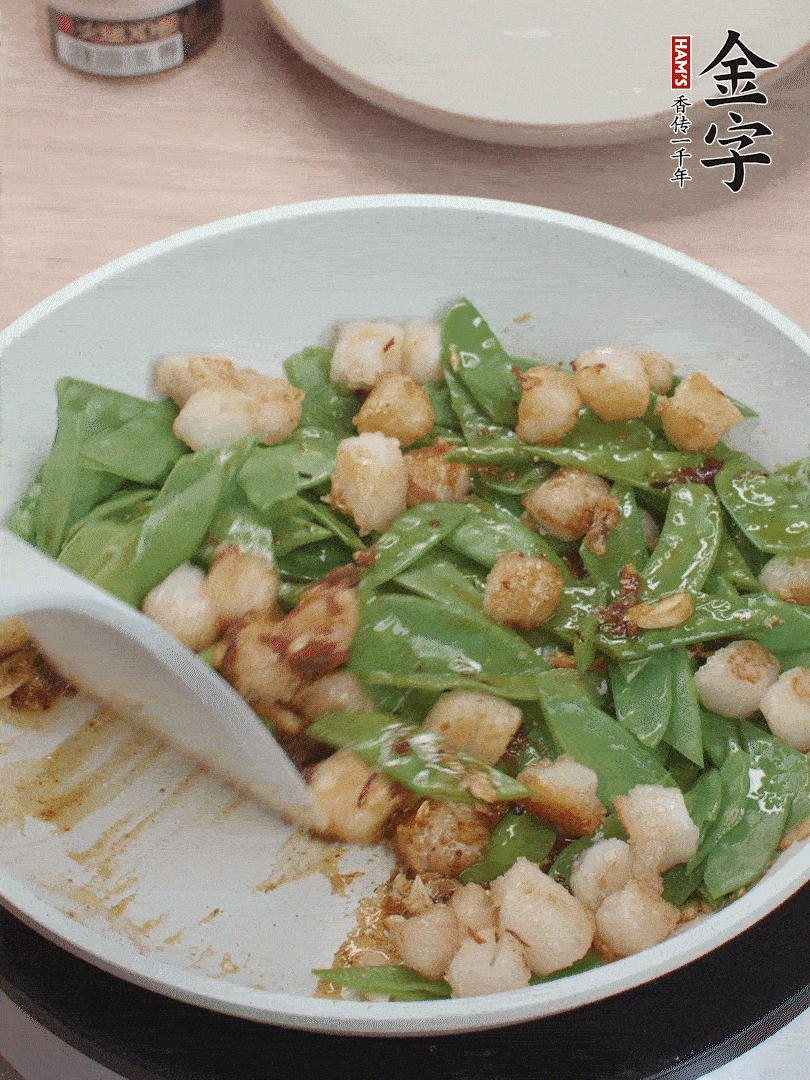下甜豆莢、鮮貝輕輕翻炒均勻。